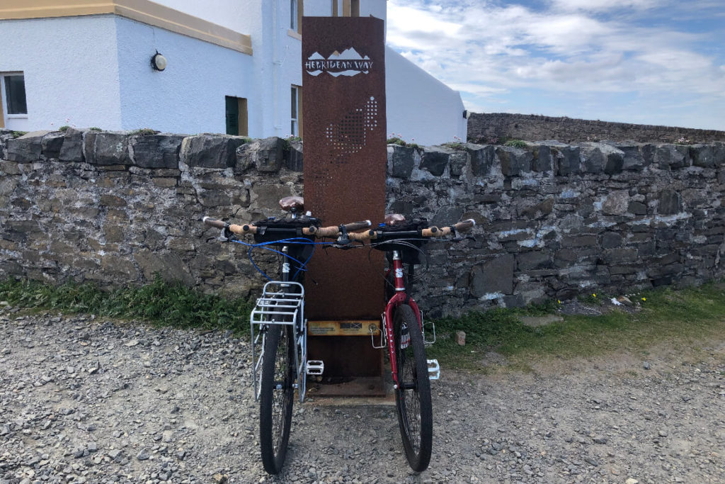 bikes next to the Hebridean Way finish marker at the Butt of Lewis lighthouse