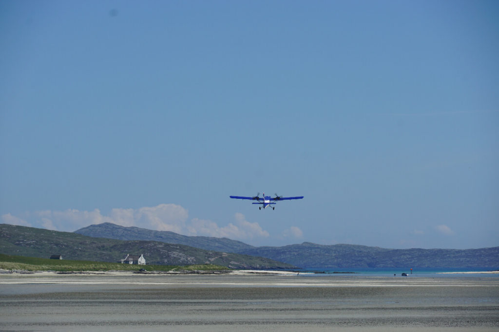 plane taking off from a beach on Barra