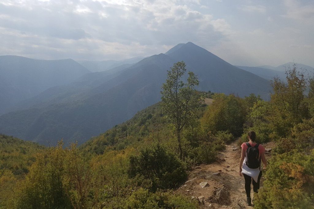 a woman hiking on a mountain trail